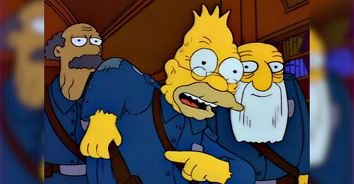 A screenshot from The Simpsons in which Grandpa Simpson is excitedly pointing at himself and his belt